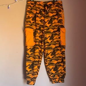ORANGE CAMO PANTS W/ ELASTIC ANKLES.